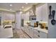 Modern kitchen featuring white cabinets, stainless steel appliances, stylish backsplash and plenty of counter space at 445 Waterfern Trail Dr, Auburndale, FL 33823