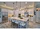 Bright, open kitchen featuring a large center island, stainless steel appliances, and modern white cabinetry at 445 Waterfern Trail Dr, Auburndale, FL 33823