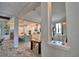 Open-concept kitchen and dining area featuring white cabinetry, modern lighting, and stylish wood-look flooring at 445 Waterfern Trail Dr, Auburndale, FL 33823