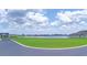 Scenic lake view with lush green space and blue skies creates a serene setting at 445 Waterfern Trail Dr, Auburndale, FL 33823