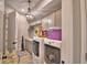 Convenient laundry room with modern appliances, ample cabinet space, and stylish lighting at 445 Waterfern Trail Dr, Auburndale, FL 33823