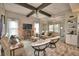 Spacious living room with vaulted ceilings, hardwood floors, comfortable seating, and a decorative entertainment center at 445 Waterfern Trail Dr, Auburndale, FL 33823