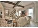Open living room featuring hardwood floors, comfortable seating, decoratively framed stairs and an entertainment center at 445 Waterfern Trail Dr, Auburndale, FL 33823