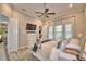 Main bedroom features hardwood floors, windows for natural light, neutral decor, and a mounted TV at 445 Waterfern Trail Dr, Auburndale, FL 33823