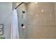 Shower with gray subway tile, black shower head and controls, plus a white shower curtain at 445 Waterfern Trail Dr, Auburndale, FL 33823
