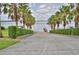 Paved access road to the lakefront with mature trees lining both sides of the road at 445 Waterfern Trail Dr, Auburndale, FL 33823