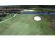 Picturesque golf course featuring a green, sand trap, and surrounding landscaping at 4488 Turnberry Ln, Lake Wales, FL 33859