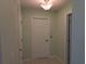 Neutral hallway with tiled floor and multiple doors at 4488 Turnberry Ln, Lake Wales, FL 33859
