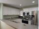 Modern kitchen showcasing stainless steel appliances, bright white cabinets, and ample counter space for meal preparation at 4488 Turnberry Ln, Lake Wales, FL 33859