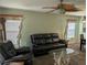 Bright living area with a comfortable sofa, tropical ceiling fan, and distinctive decorative elements creating a cozy atmosphere at 4488 Turnberry Ln, Lake Wales, FL 33859