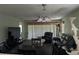 Inviting living room featuring plush seating, a ceiling fan, and ample natural light at 4488 Turnberry Ln, Lake Wales, FL 33859