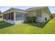 View of the backyard featuring a screened lanai and well-kept lawn, perfect for outdoor enjoyment at 469 Sweetwater Way, Haines City, FL 33844