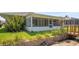 View of a backyard with a screened-in porch and lush green grass at 469 Sweetwater Way, Haines City, FL 33844