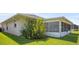 Well-maintained backyard with lush greenery and a screened lanai, offering a private outdoor space at 469 Sweetwater Way, Haines City, FL 33844