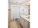 Bathroom with shower and tub combination, vanity with drawers, and neutral flooring at 469 Sweetwater Way, Haines City, FL 33844