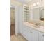 Bathroom with white vanity, marble countertop, storage cabinet and walk-in closet at 469 Sweetwater Way, Haines City, FL 33844