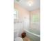 Bathroom with a shower and tub combination, toilet, and neutral paint at 469 Sweetwater Way, Haines City, FL 33844