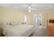 Bedroom with ceiling fan, neutral walls, and access to a sunroom at 469 Sweetwater Way, Haines City, FL 33844