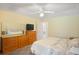 Bedroom with hardwood dresser and a view to the ensuite bathroom at 469 Sweetwater Way, Haines City, FL 33844