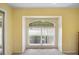 Bright bedroom with neutral carpet and large window showcasing the yard at 469 Sweetwater Way, Haines City, FL 33844