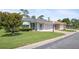 Charming single-story home with brick driveway and lush green front lawn at 469 Sweetwater Way, Haines City, FL 33844