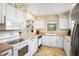 Functional kitchen with white cabinets and updated appliances at 469 Sweetwater Way, Haines City, FL 33844