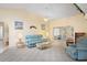Comfortable living room with carpet flooring and view to sunroom at 469 Sweetwater Way, Haines City, FL 33844