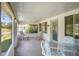 Covered porch with cozy seating, and plenty of space for relaxing at 469 Sweetwater Way, Haines City, FL 33844