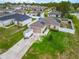 Exterior view of a well-maintained home with solar panels, a large driveway, and fenced-in backyard at 47 Willow Ln, Kissimmee, FL 34759