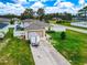 Lovely single-story home featuring a well-kept lawn, concrete driveway, and solar panels on the roof at 47 Willow Ln, Kissimmee, FL 34759