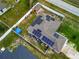 Aerial view of a home featuring solar panels on the roof, a fenced yard, and an outbuilding at 47 Willow Ln, Kissimmee, FL 34759