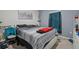 Bedroom features sleek gray walls, bed with striped duvet, and minimalist decor at 47 Willow Ln, Kissimmee, FL 34759