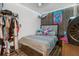 Comfortable bedroom with a plush bed, wood accent wall, and decorative accents at 47 Willow Ln, Kissimmee, FL 34759