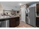Spacious kitchen with stainless steel appliances, ample countertop space, and dark wood cabinets at 47 Willow Ln, Kissimmee, FL 34759