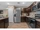Well-equipped kitchen featuring stainless steel appliances, dark cabinetry, and a functional layout at 47 Willow Ln, Kissimmee, FL 34759