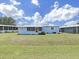 A cozy home with a screened in porch and green grass yard at 4859 Foxwood Blvd, Lakeland, FL 33810