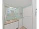 Bright bathroom features a sink vanity, mirror, and artwork complementing the mint green walls at 4859 Foxwood Blvd, Lakeland, FL 33810
