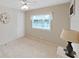 Bedroom featuring a ceiling fan, large window, and neutral decor at 4859 Foxwood Blvd, Lakeland, FL 33810