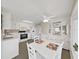 Open-concept kitchen and dining area with white cabinetry and appliances at 4859 Foxwood Blvd, Lakeland, FL 33810