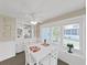 Charming dining area featuring white table and chairs, a built-in cabinet, and large windows at 4859 Foxwood Blvd, Lakeland, FL 33810