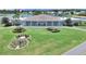 Aerial view of community clubhouse with manicured landscaping and lake views at 4859 Foxwood Blvd, Lakeland, FL 33810