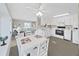 Kitchen and dining area with white cabinets and appliances, and views to living room at 4859 Foxwood Blvd, Lakeland, FL 33810