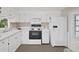 Bright kitchen featuring white cabinets and appliances, and plenty of counter space at 4859 Foxwood Blvd, Lakeland, FL 33810