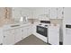 Clean kitchen with white cabinets and appliances, and neutral wall color at 4859 Foxwood Blvd, Lakeland, FL 33810