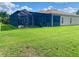 Beautiful backyard featuring a screened-in lanai perfect for enjoying the outdoors, plus a well-manicured lawn at 5005 Pebble Beach Blvd, Winter Haven, FL 33884