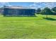 Expansive backyard with a screened-in patio, perfect for outdoor enjoyment at 5005 Pebble Beach Blvd, Winter Haven, FL 33884