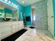 Modern bathroom features stylish tile, a large mirror, and walk-in shower at 5005 Pebble Beach Blvd, Winter Haven, FL 33884