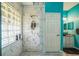 Bright bathroom featuring a marble tiled shower with glass block window and modern vanity at 5005 Pebble Beach Blvd, Winter Haven, FL 33884