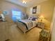 Bedroom featuring coastal decor, complemented by a bright window and ceiling fan at 5005 Pebble Beach Blvd, Winter Haven, FL 33884