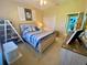 Bedroom boasting beach-themed decor, paired with natural light and ample closet space at 5005 Pebble Beach Blvd, Winter Haven, FL 33884